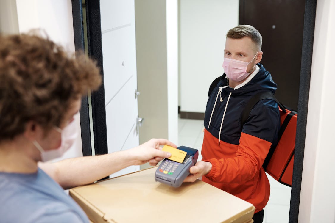 A delivery driver receiving payment for the service