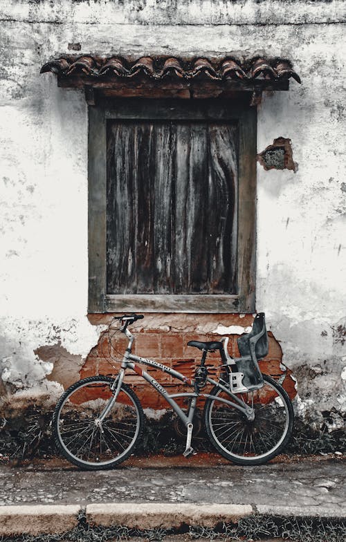 A Bicycle Parked in Front of a Window