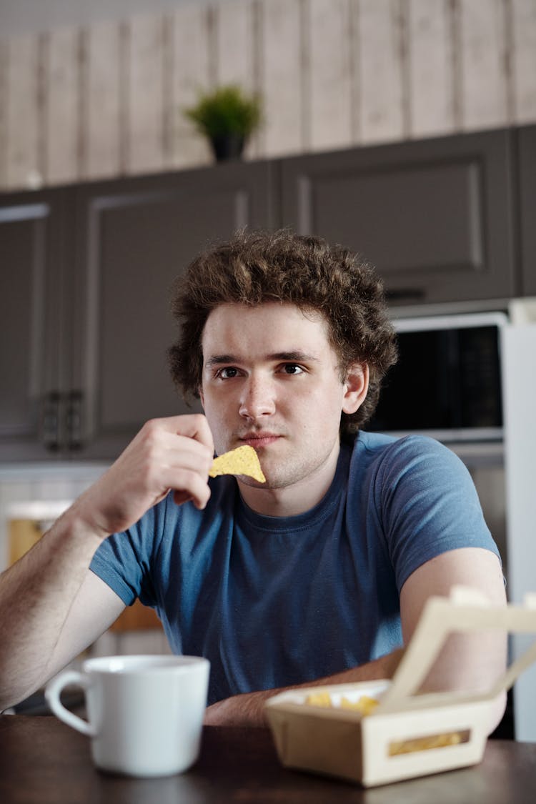 A Man Eating Nachos