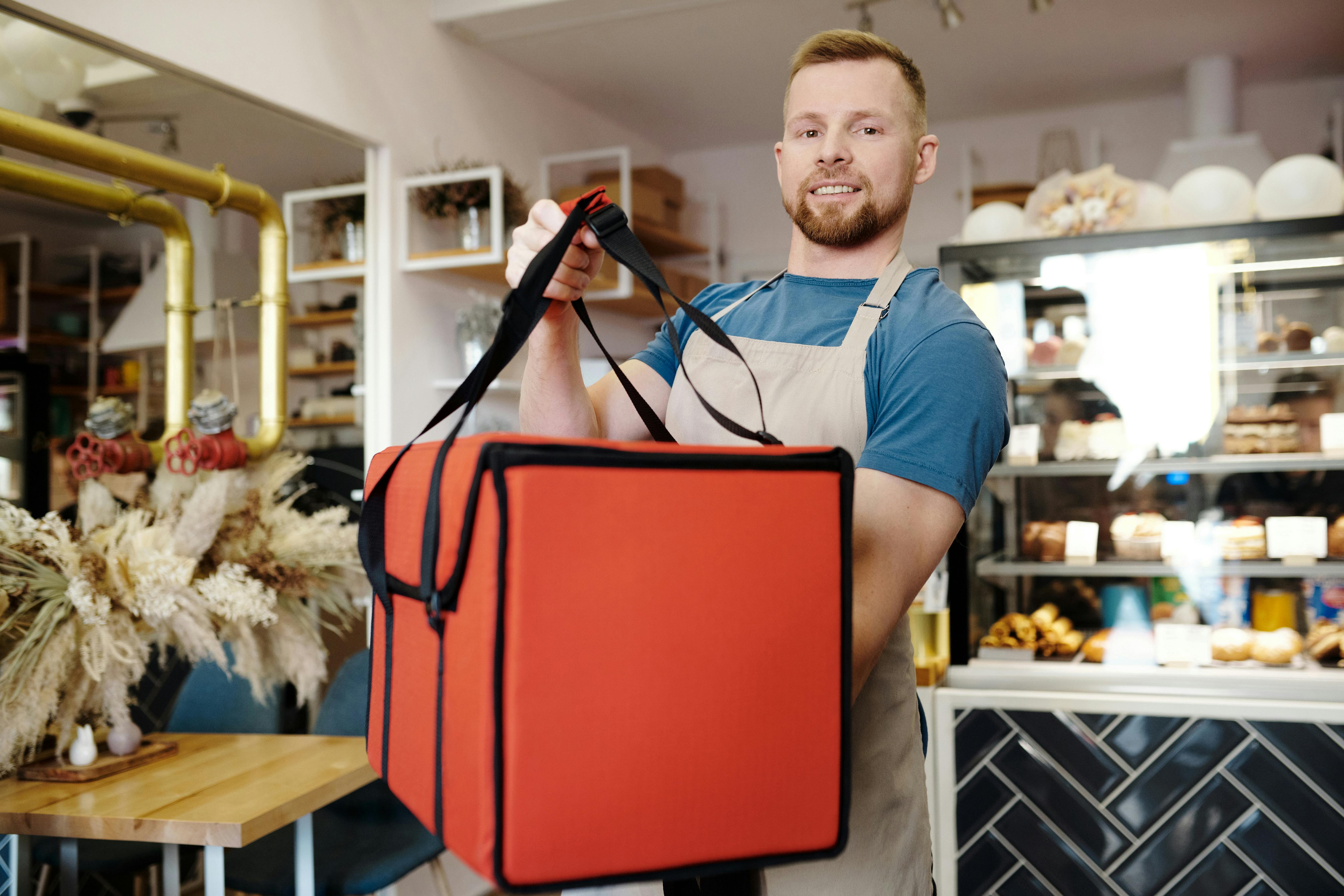 smiling blonde man with bag