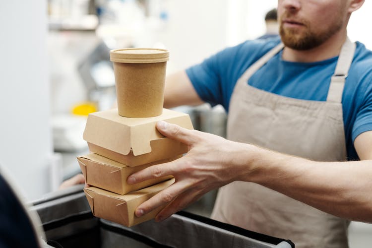 A Man Holding Takeaway Cardboards