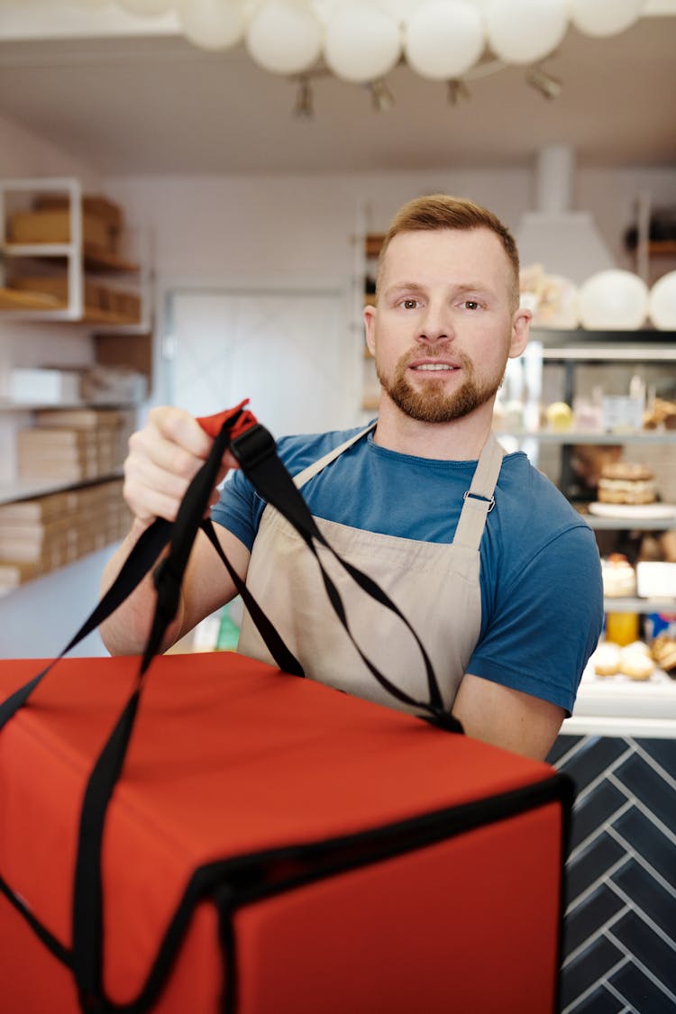 A Man Holding A Delivery Thermal Bag