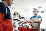 Man With a Face Mask Holding a Thermal Bag