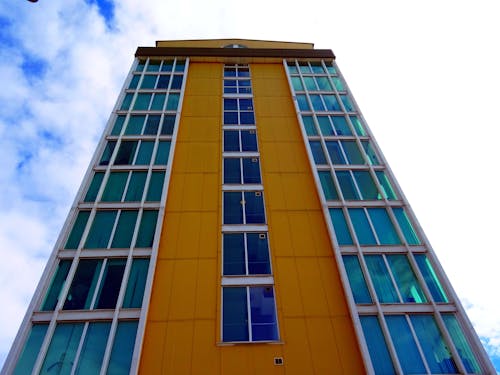 Brown and Blue Building Under Cloudy Sky