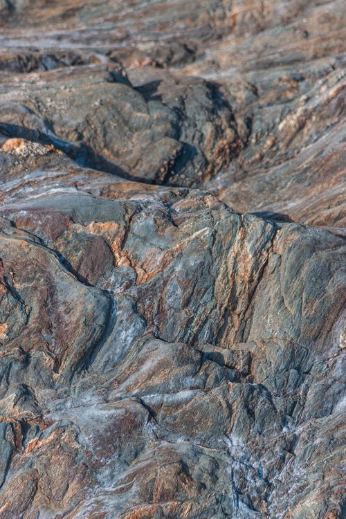 Free Drone view of formation of multi colored bare rocks in mountain ravine in daylight Stock Photo