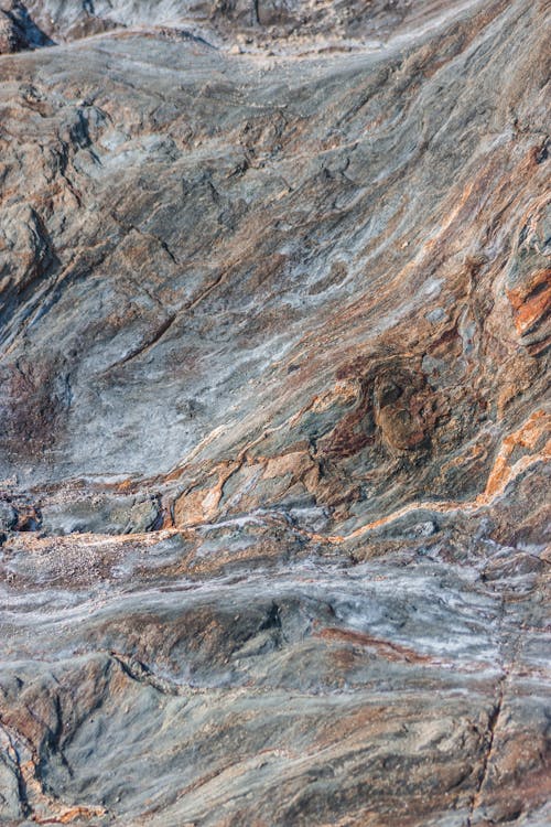 Drone view of light blue orange plain rocks and slopes in canyon in sunlight