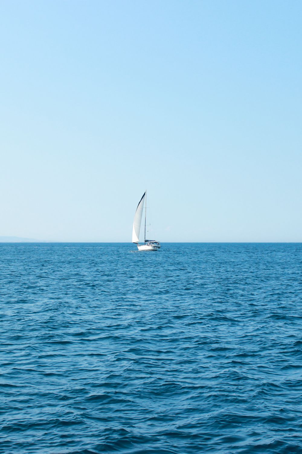 Sailboat on blue water for a Yacht Rock music theme