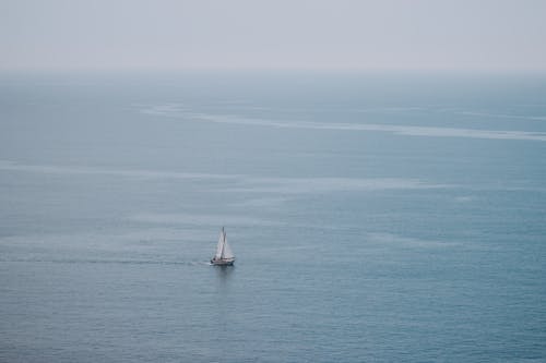 Sailboat on sea on cloudy day