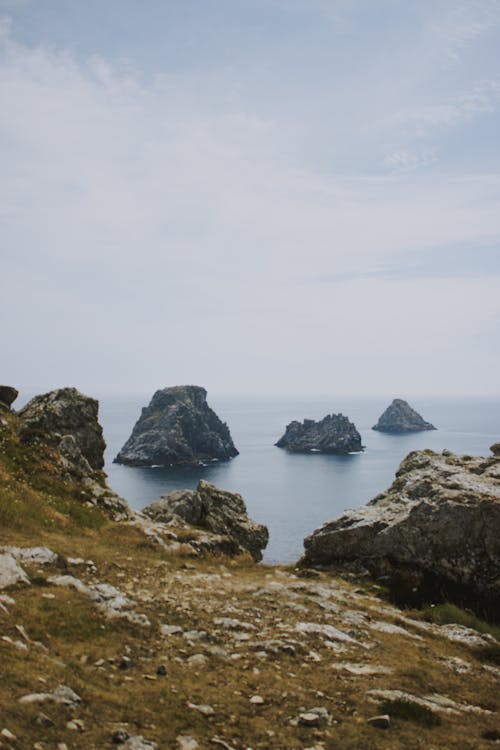 Rocky coast near sea on cloudy day