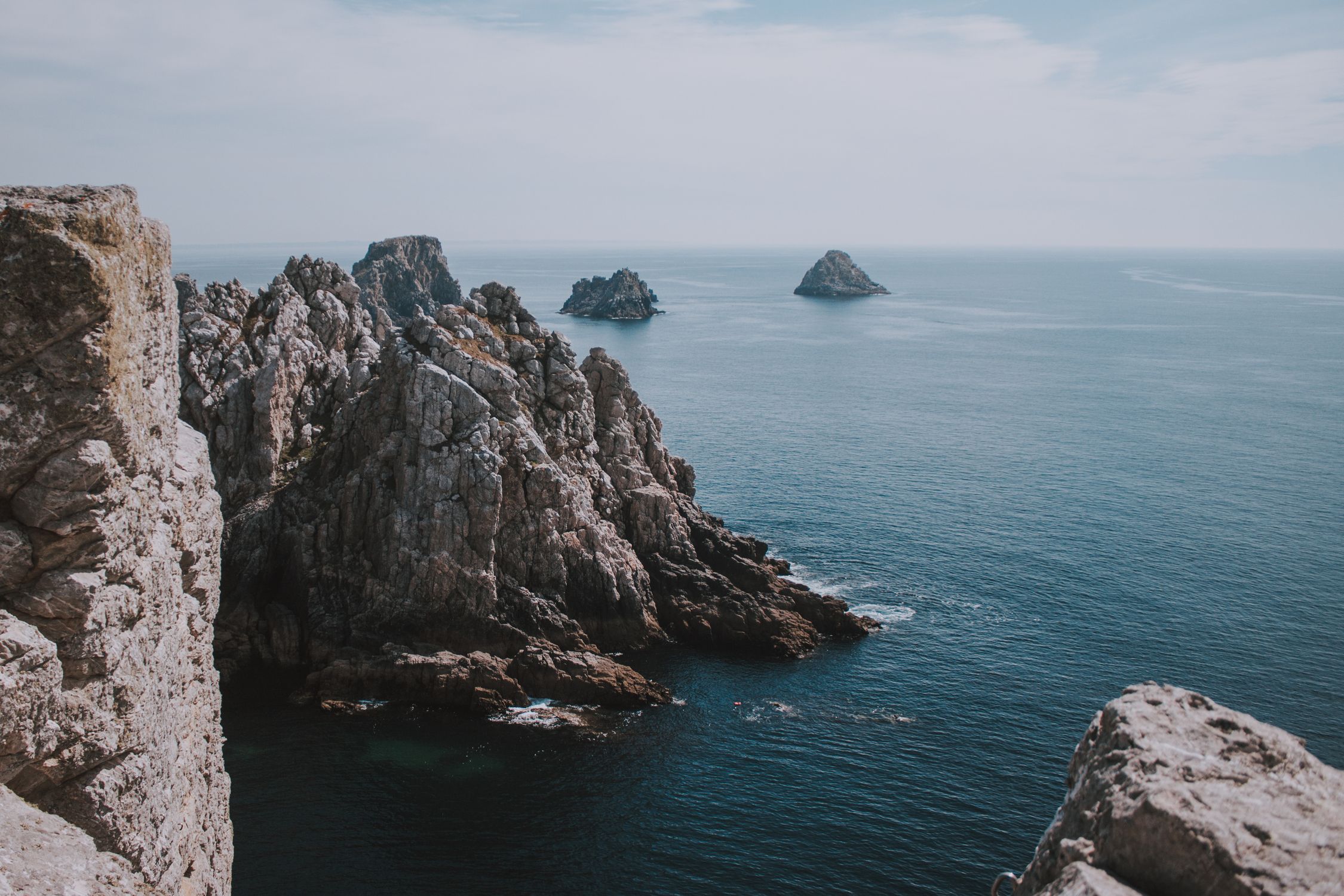 Seascape with rocks under blue sky · Free Stock Photo