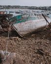 Broken boat on beach in port