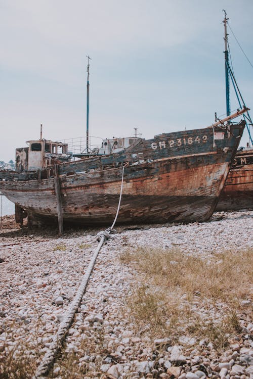 Old boat on beach near sea · Free Stock Photo