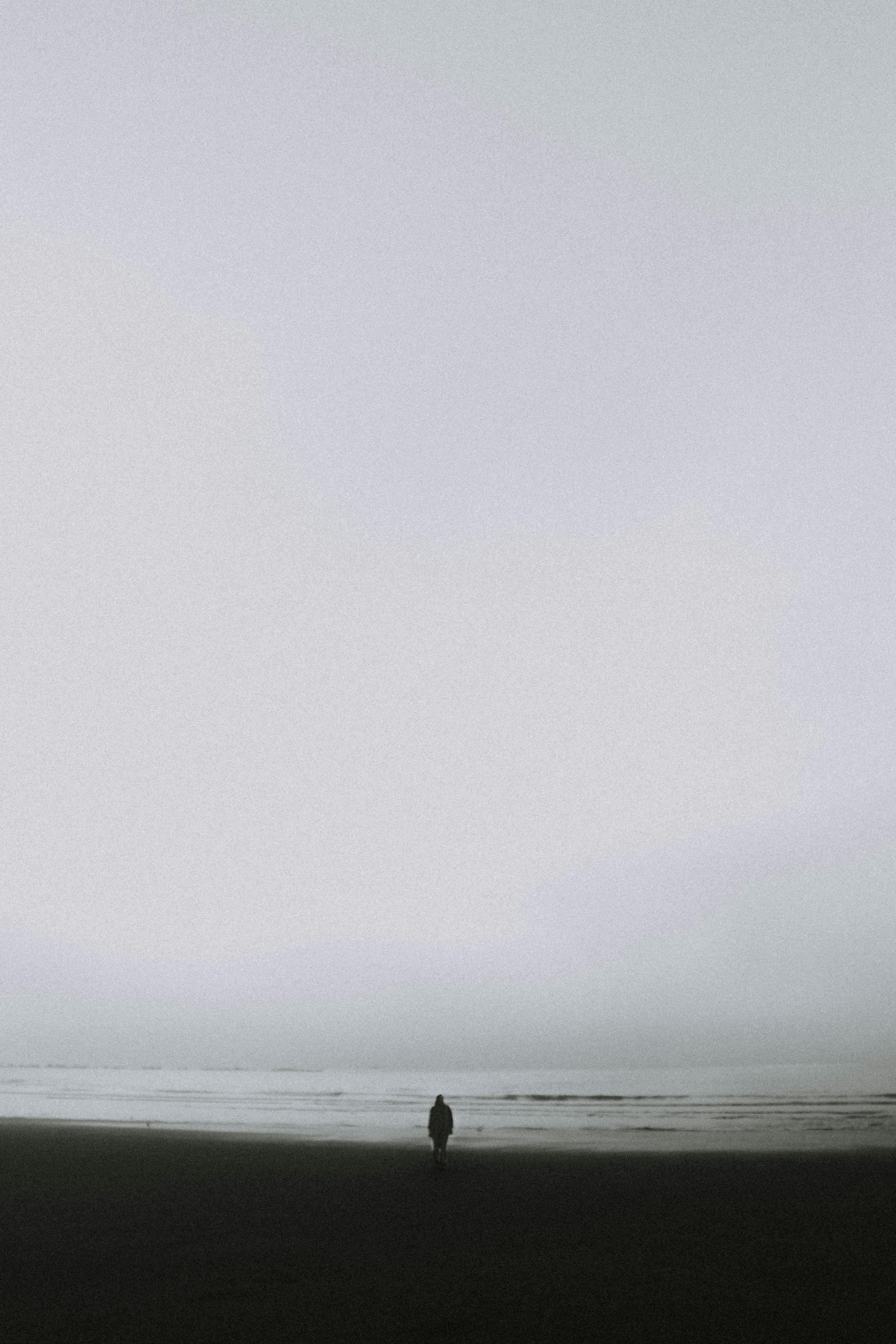 lonely person standing on seashore