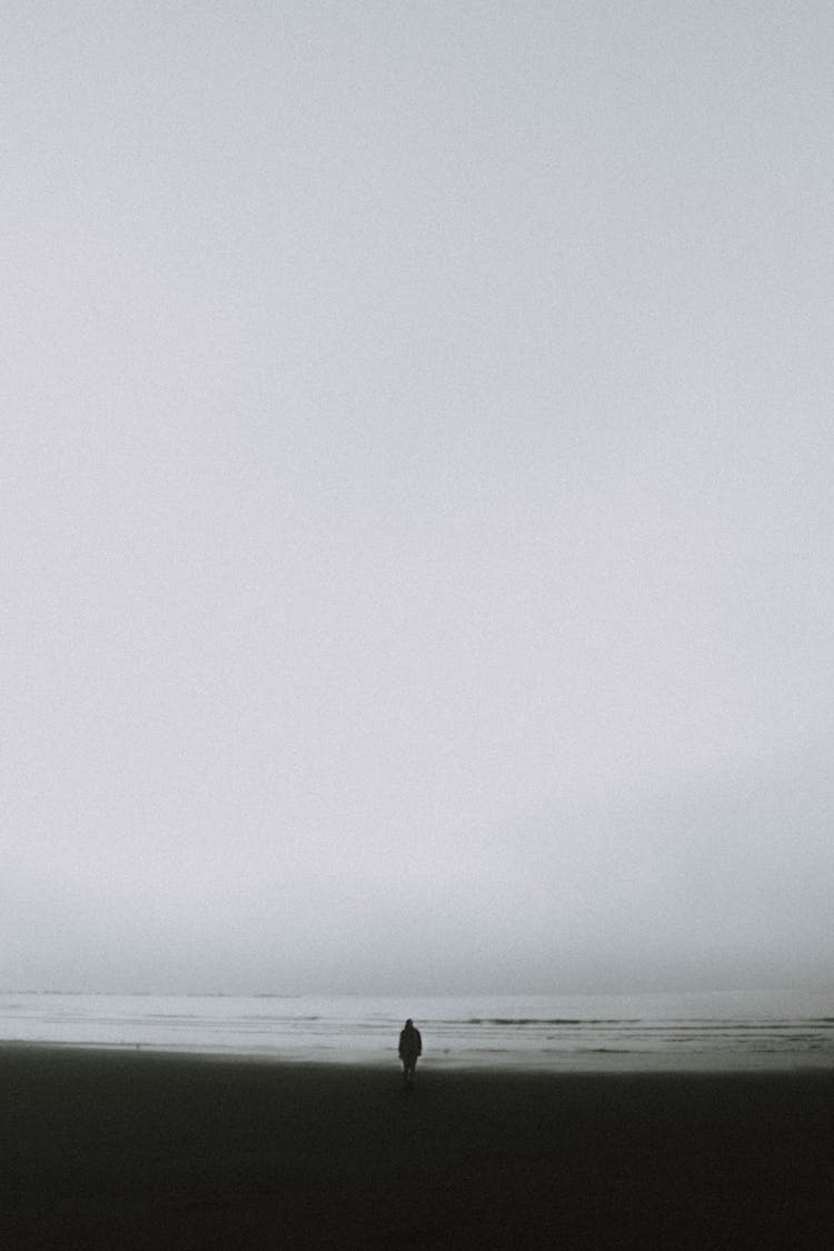 Lonely Person Standing On Seashore