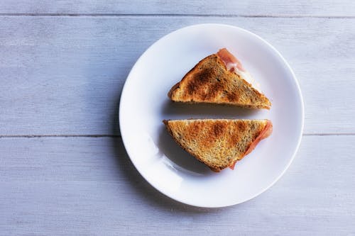 Free Toasted Sandwich with Cheese and Ham on a Plate Stock Photo