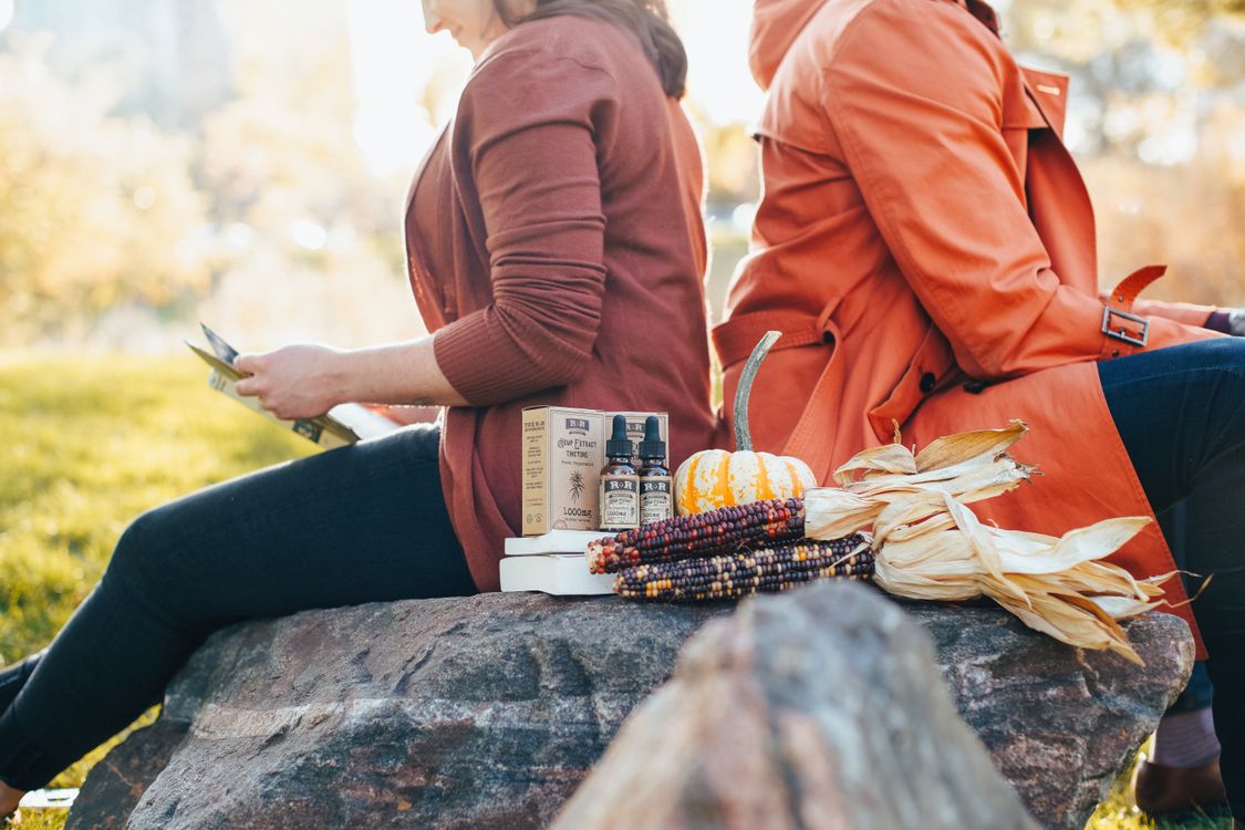 Two Women Sitting on a Rock · Free Stock Photo
