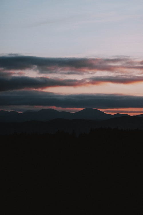 High mountains against amazing cloudy sunset sky