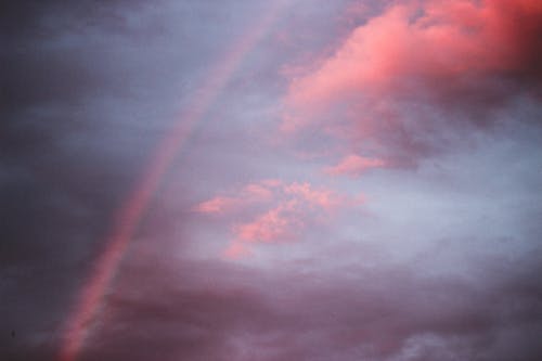 Free Amazing cloudy sunset sky with rainbow Stock Photo