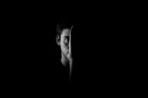 Free Artistic black and white portrait showing half of a man's face with contrasting shadows. Stock Photo