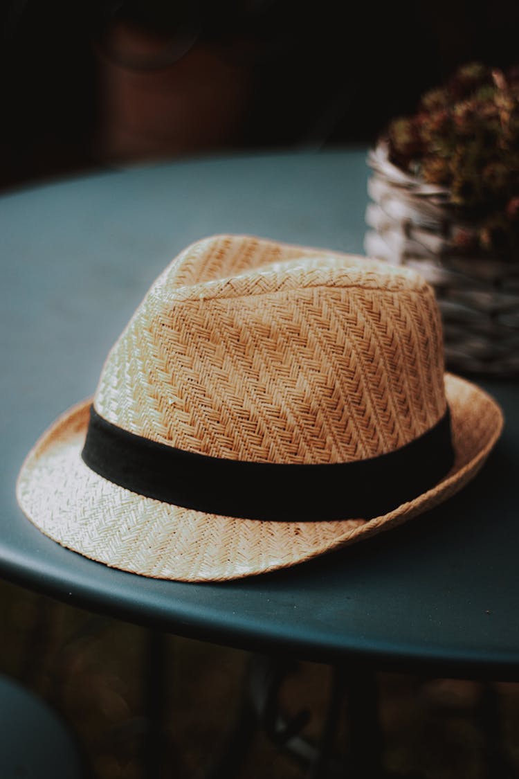 Trendy Wicker Straw Hat Placed On Table In Cafeteria