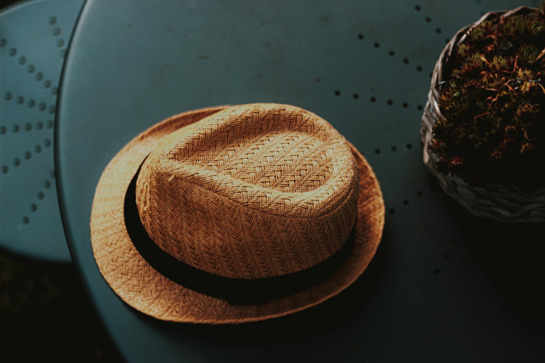 Wicker straw hat on round table