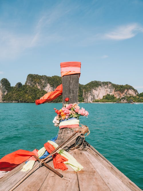 Bow of a Wooden Boat Sailing to the Island Decorated with Flowers