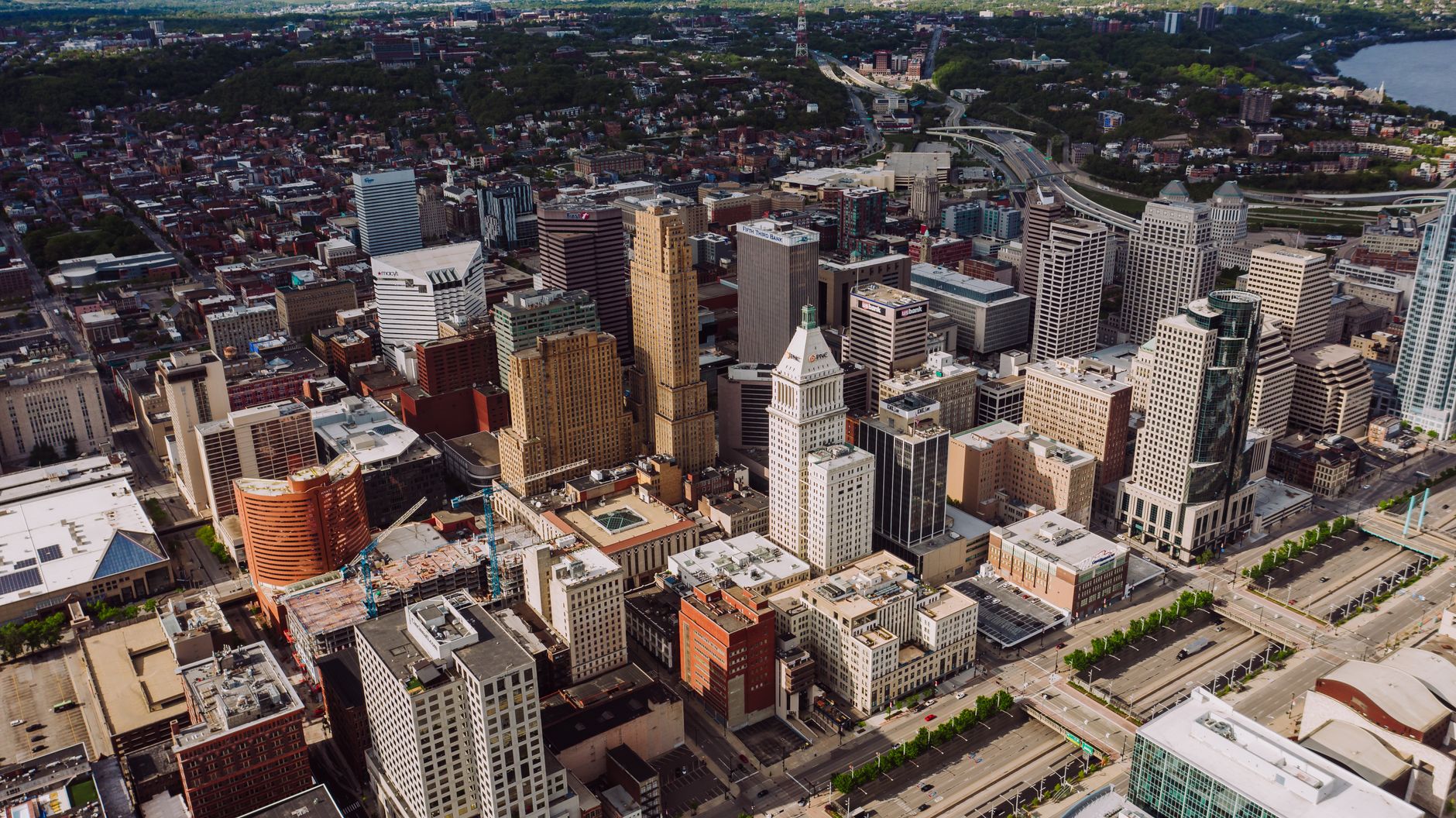 From above of small park surrounded by skyscrapers and high multi storey buildings next to settlement and junction in USA