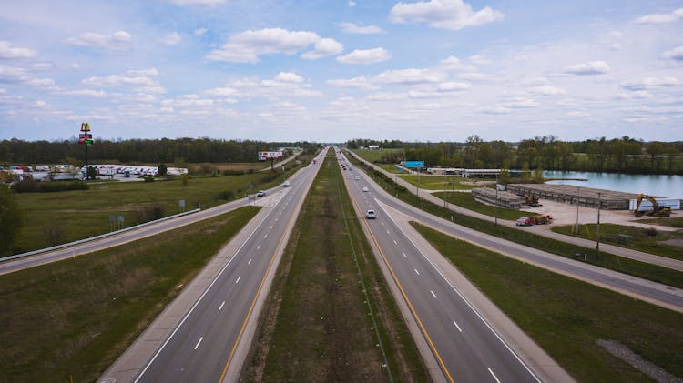 Cars Riding Along Road Near River