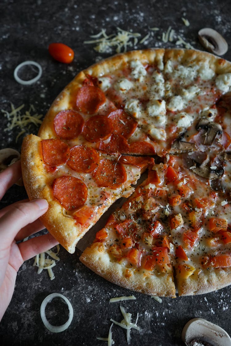 Faceless Person With Slice Of Yummy Pizza At Home