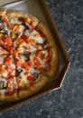 Yummy pizza with pepper slices in cardboard box