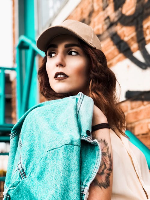 Portrait of a Woman Looking Away while Holding Her Denim Jacket