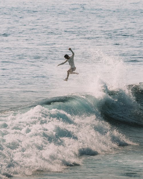 Surfer Jumping on Big Wave 