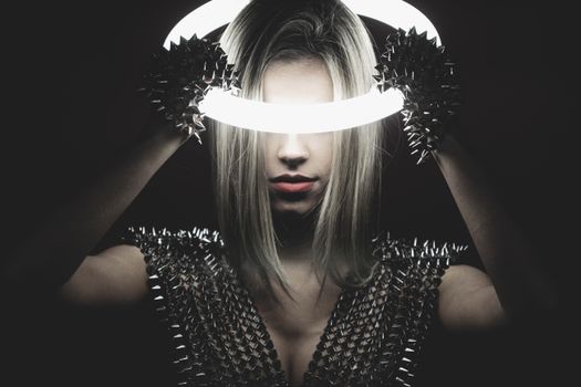 A striking portrait of a woman with a ring light, exuding a modern, edgy vibe.
