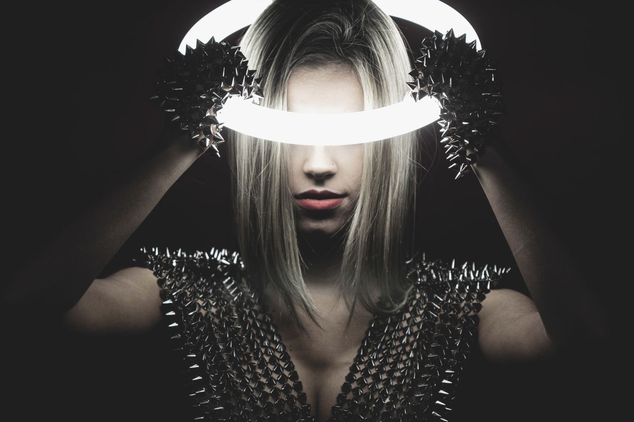 a striking portrait of a woman with a ring light exuding a modern edgy
