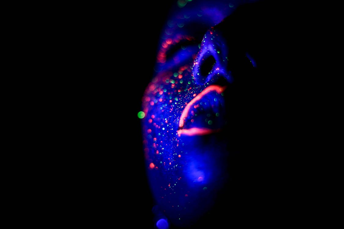 Free Person with Glowing Paint on Face Stock Photo