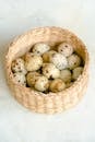 Brown and White Eggs in Brown Woven Basket
