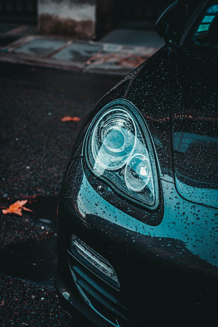 Headlamp Of Modern Car With Water Drops On Surface