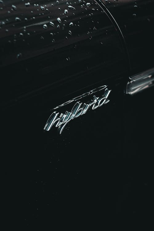 Free From above of contemporary black hybrid auto with creative title and water droplets on surface Stock Photo