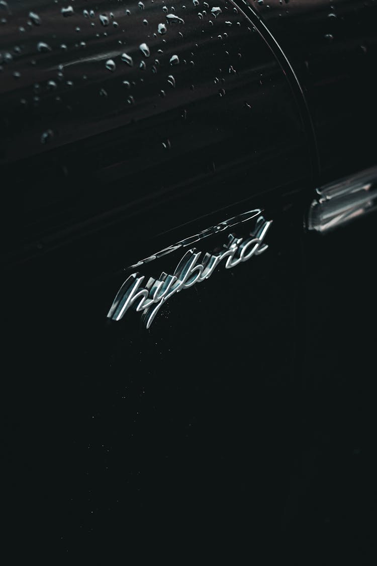 Modern Car With HYBRID Logotype And Water Drops