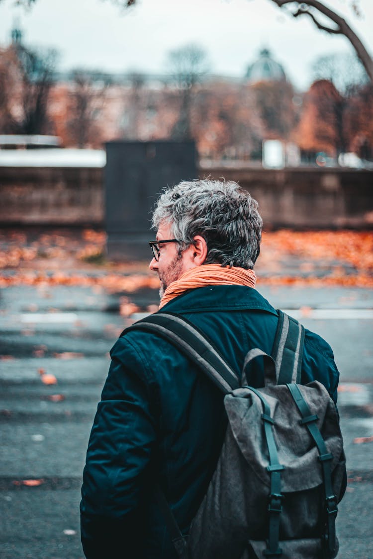 Unrecognizable Stylish Mature Man With Backpack On City Street