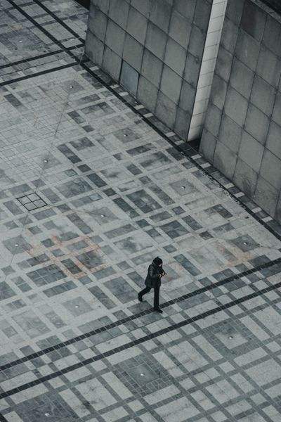 Overhead view of a person crossing pavement — Mathias Reding on Pexels