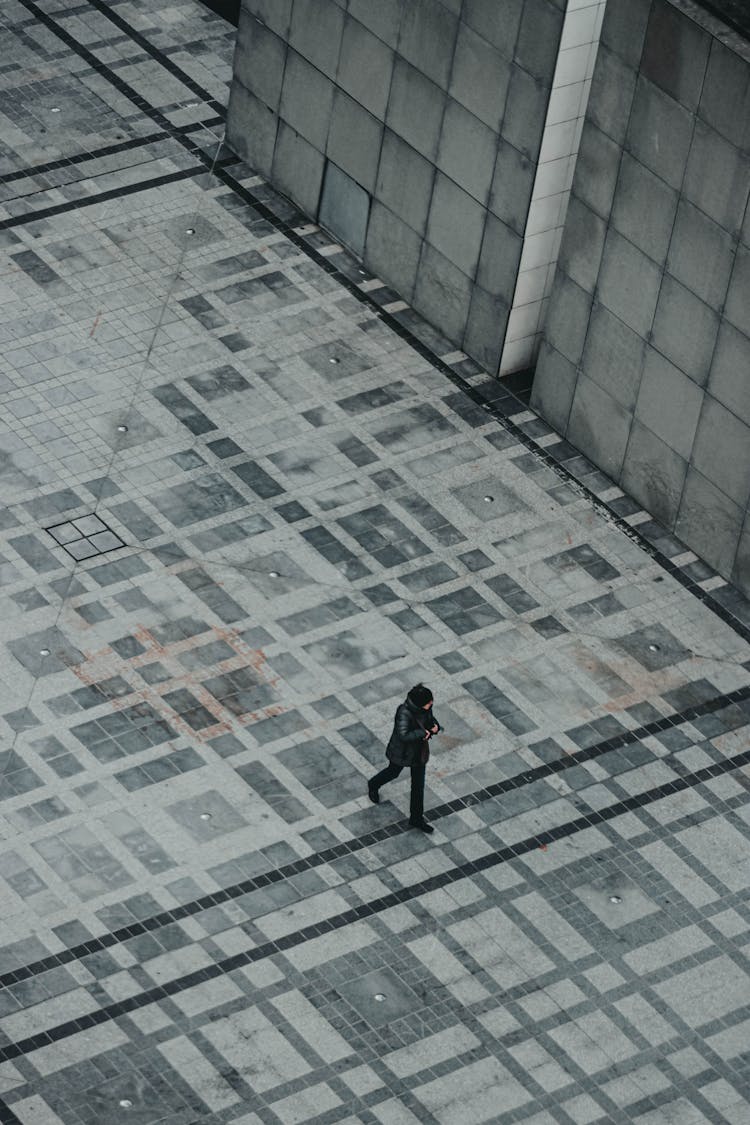 Person Walking On Concrete Floor In Downtown