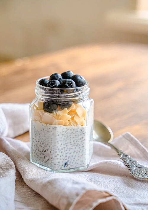 Jar of Chia Seed Pudding Next to a Spoon