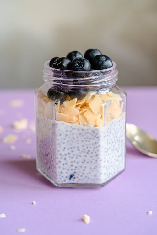 Chia Seed Pudding Topped with Almond Flakes and Blueberries in a Jar