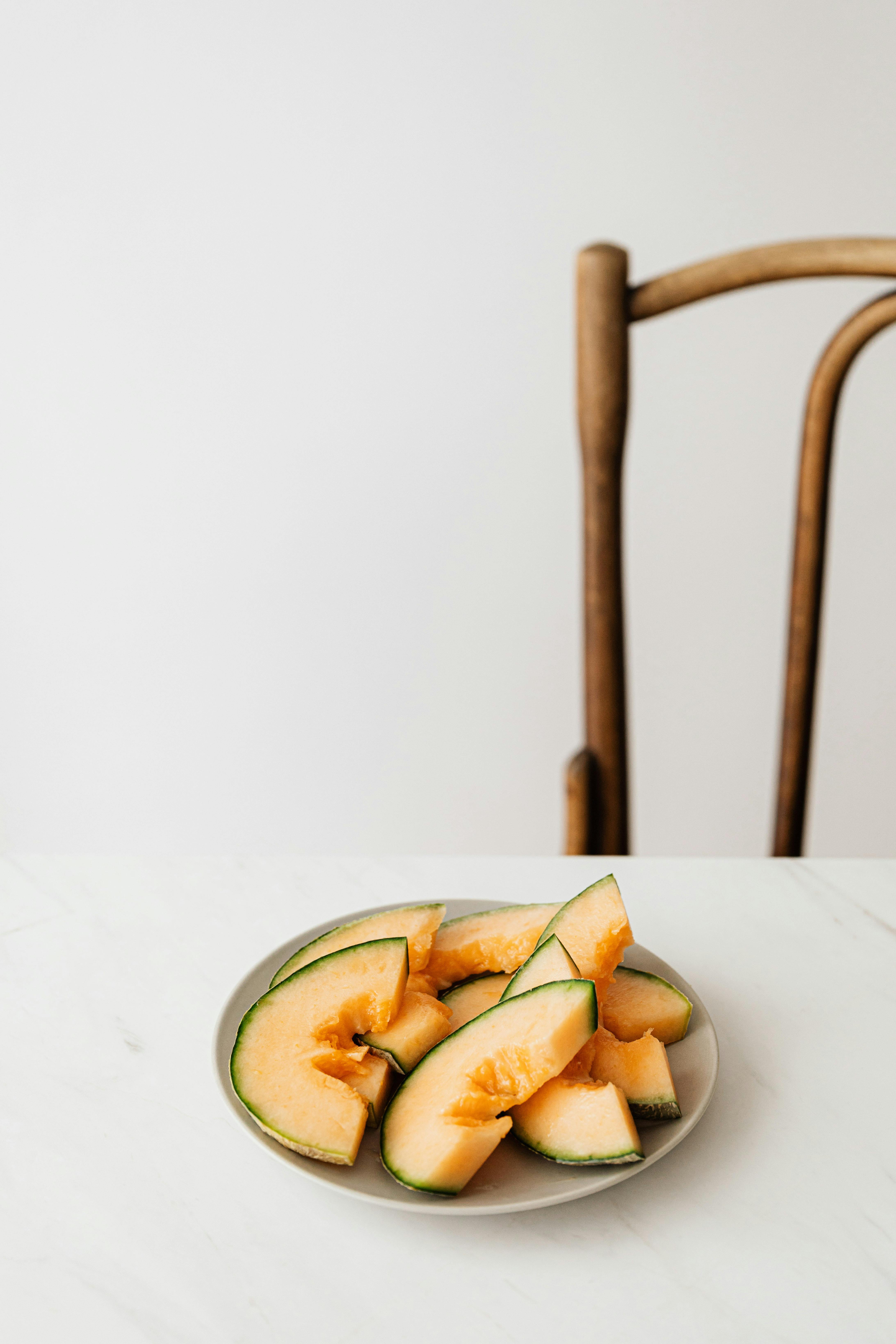 plate of delicious sliced melon placed on white table