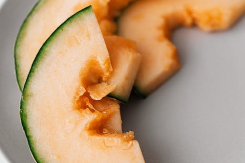 Healthy sweet sliced melon on gray plate