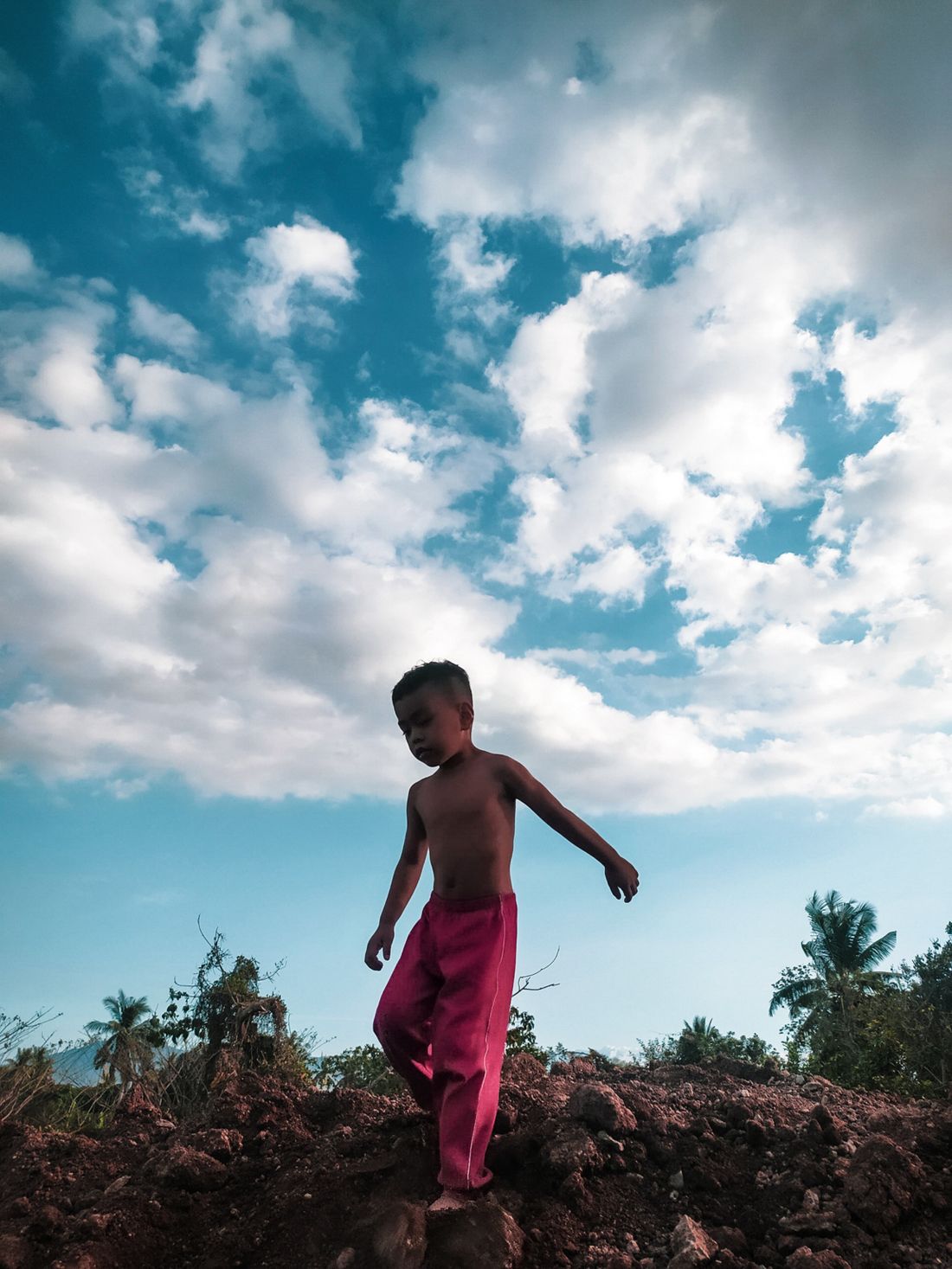 A young boy walking outdoors