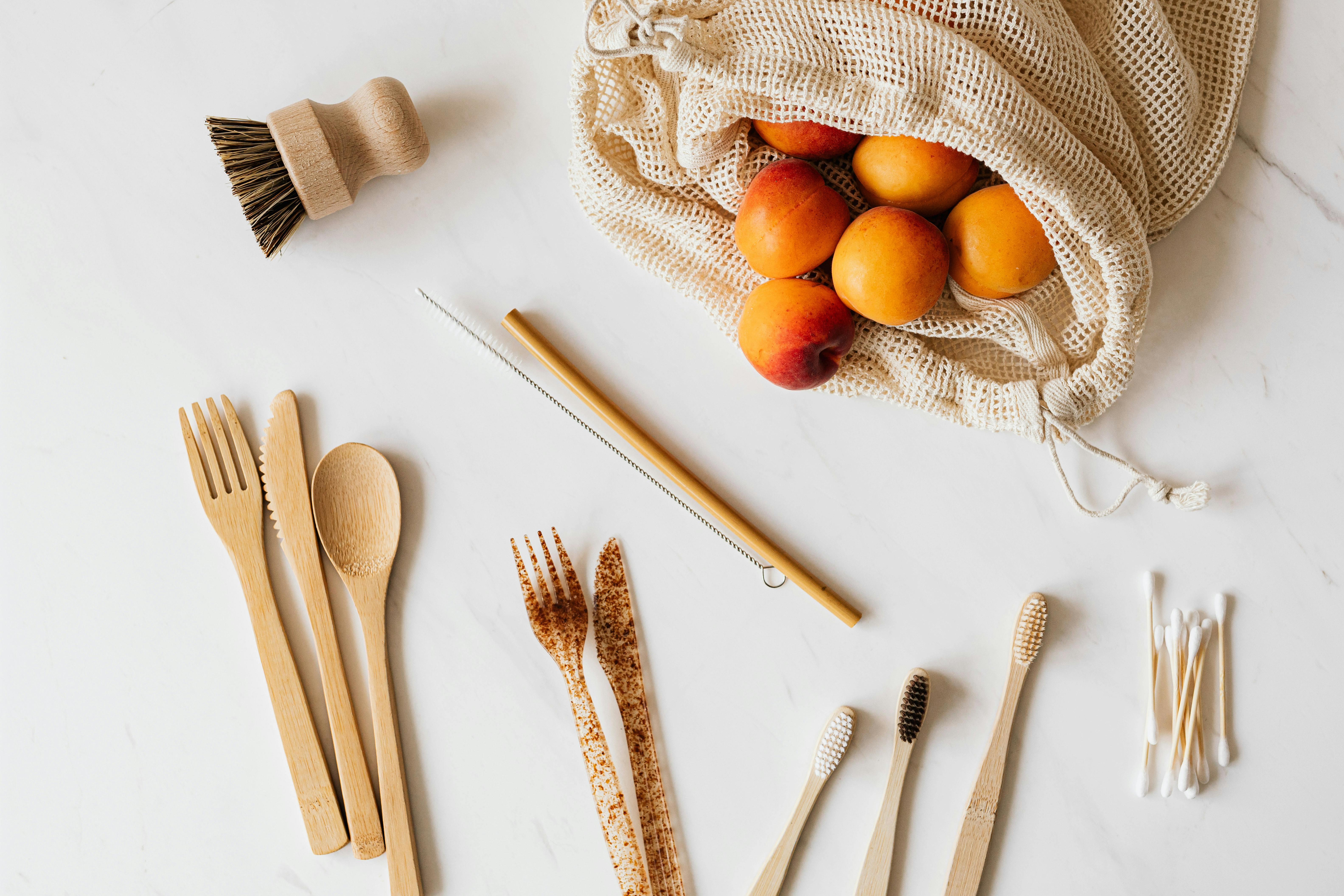 set of various cutlery and wash accessories near peaches