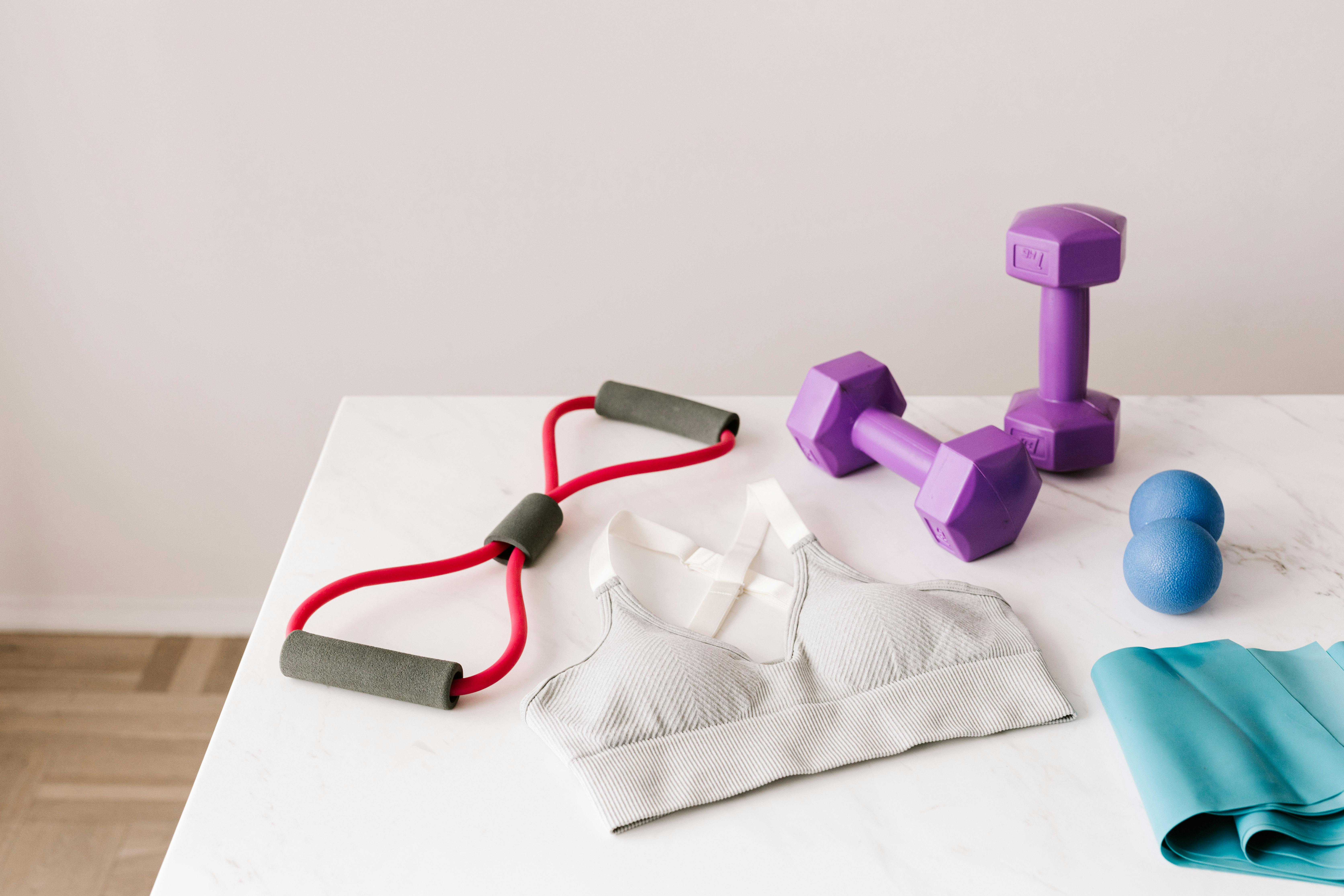 set of sports equipment and bra for training placed on marble table