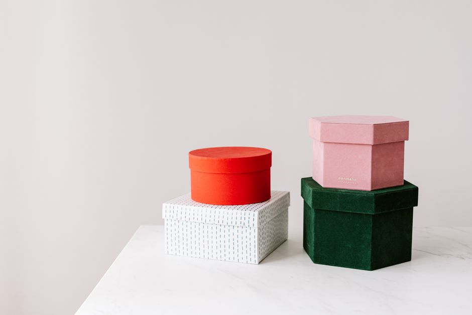 Stylish gift boxes in various colors arranged on a marble surface, perfect for celebrations.
